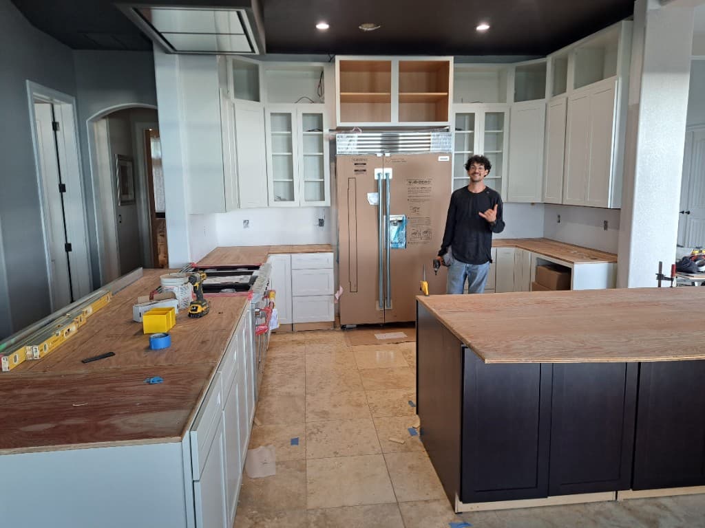 Aaron in a kitchen renovation with new cabinets and island